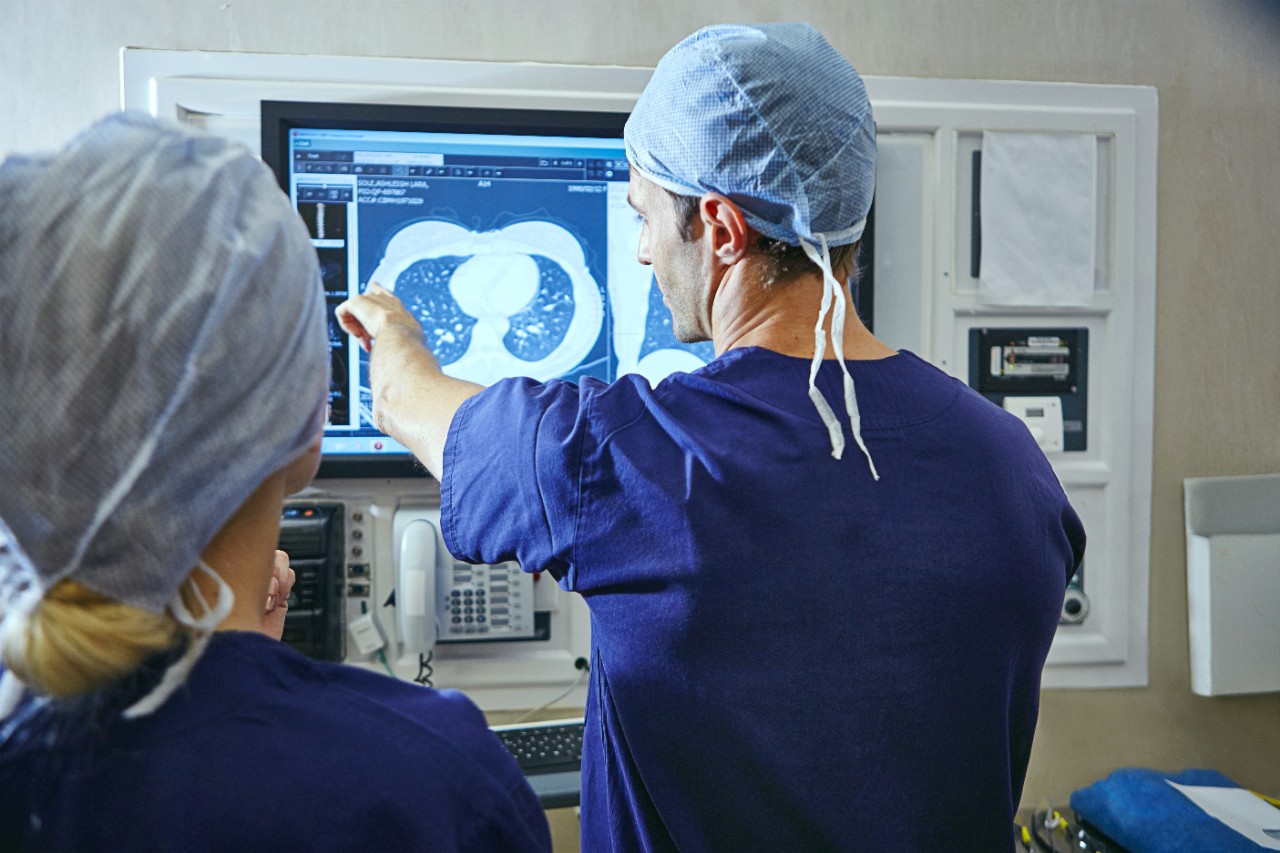 Doctor showing x-ray on screen with another doctor