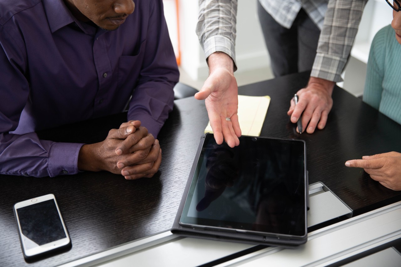 Team meeting around a tablet